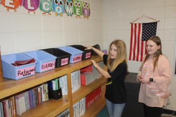 Tour guides Jaelen Kersey, left, and Hailee Harrison show subject boxes in Elizabeth Moseley’s fifth-grade classroom.