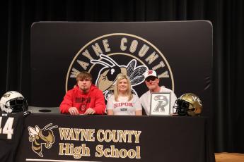 Wayne County High senior defensive end Bradley Wood, left, signed a letter of intent to play football next season at Ripon College in Wisconsin. He is joined by his parents Sheree and Lance Wood. 